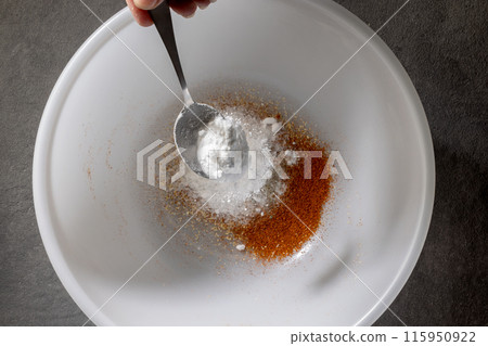 chef add baking powder into a white bowl 115950922