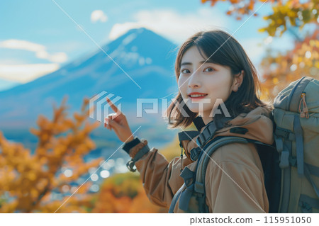 Portrait of a young Asian woman hiking/climbing in the mountains with autumn leaves 115951050