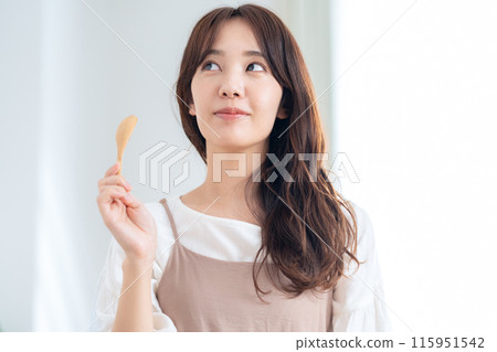 A young woman eating a salad A young woman eating a salad 115951542
