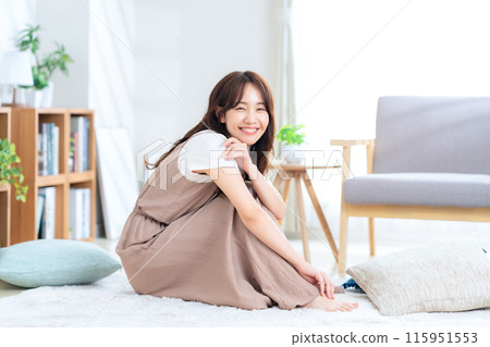 Young woman relaxing in the living room Young woman relaxing in the living room 115951553