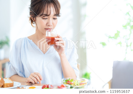 A young woman eating breakfast A young woman eating breakfast 115951637