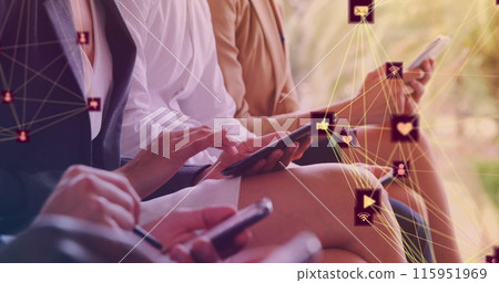 Image of media icons over diverse business people using smartphone Image of media icons over diverse business people using smartphone 115951969
