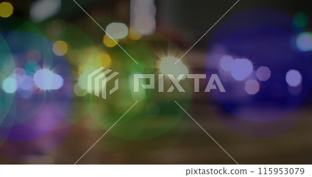 Image of glowing vibrant spots of light over out of focus road traffic and pedestrians 115953079