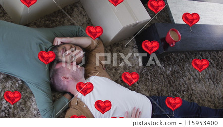 Image of heart icons over diverse gay couple lying Image of heart icons over diverse gay couple lying 115953400