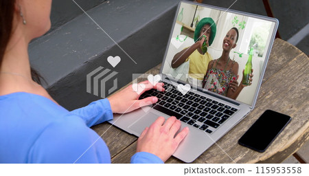 Multiple white heart icons floating over caucasian girl having a imagecall on laptop at a cafe Multiple white heart icons floating over caucasian girl having a imagecall on laptop at a cafe 115953558