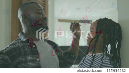 Image of biracial father and daughter with ruler over letters Image of biracial father and daughter with ruler over letters 115954282