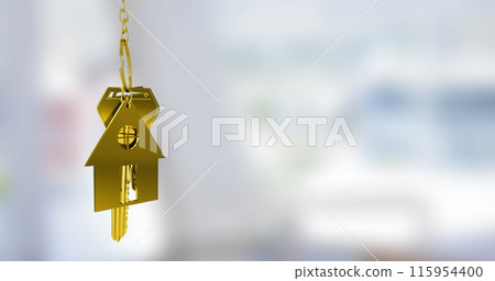 Image of gold house key fob and key dangling over out of focus interiors with copy space 115954400