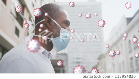 Image of covid 19 cells over african american man wearing face mask 115954826