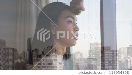 Image of cityscape over biracial woman looking through window 115954868
