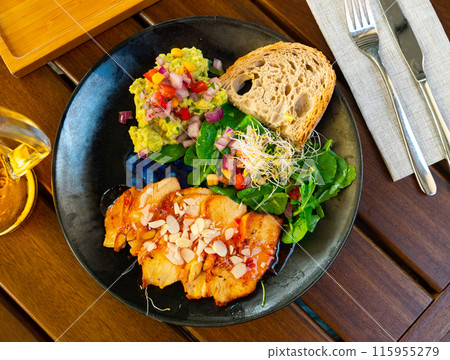 Chicken breast with guacamole, greens and salsa 115955279