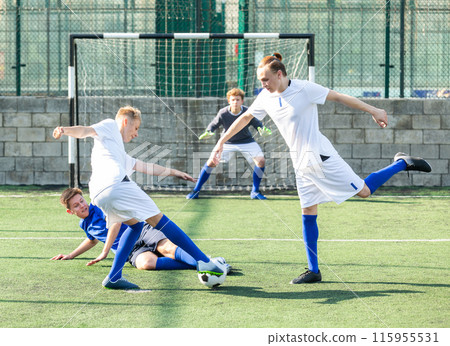 Junior football teams having scrimmage Junior football teams having scrimmage 115955531