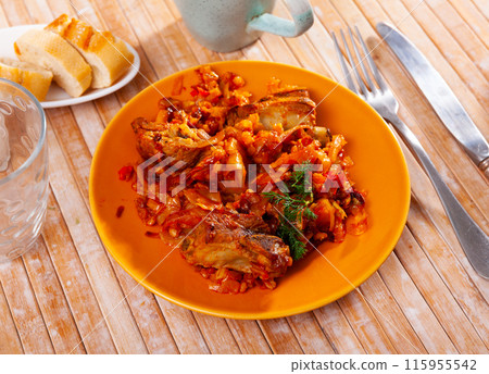 Delicious pork ribs in gravy with barley and cabbage stewed close up Delicious pork ribs in gravy with barley and cabbage stewed close up 115955542