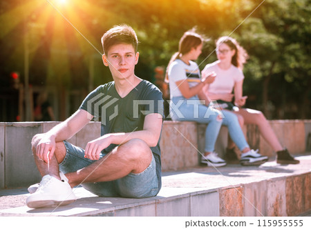 Confident teen boy spending time outdoors in summer Confident teen boy spending time outdoors in summer 115955555