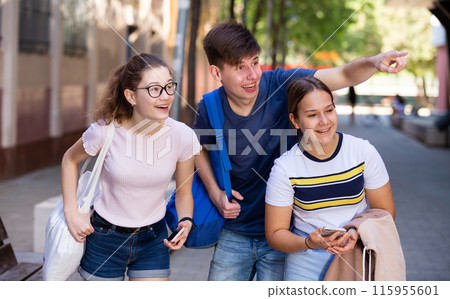 Cheerful teenagers hanging out on city streets in summer Cheerful teenagers hanging out on city streets in summer 115955601