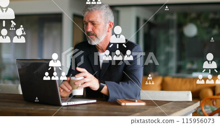 Image of flowcharts over caucasian man drinking coffee while working on laptop 115956073