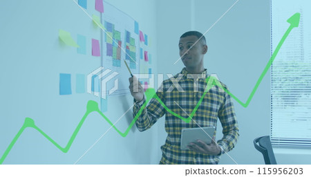 Image of financial graphs and data over biracial man working in office Image of financial graphs and data over biracial man working in office 115956203
