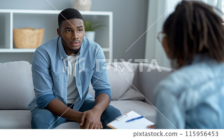 Male Patient Sitting on a Couch During Therapy 115956453