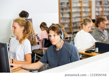 Schoolboy and schoolgirl working with computers in class room Schoolboy and schoolgirl working with computers in class room 115956548