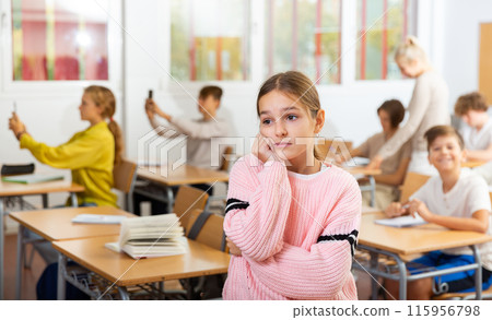 Girl feeling upset after getting bad mark at school 115956798