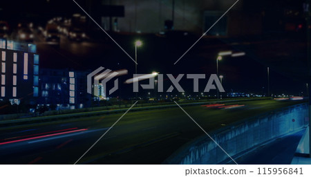 Image of road traffic in city at night in fast motion with city lights and light trails in the foreg Image of road traffic in city at night in fast motion with city lights and light trails in the foreg 115956841