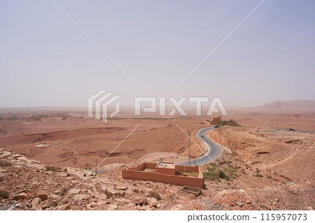 landscape with a field and winding road landscape with a field and winding road 115957073