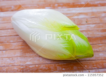 Raw organic endives on wooden table Raw organic endives on wooden table 115957352