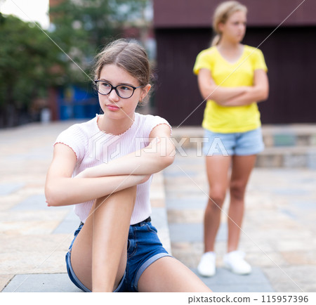 Two girlfriends after quarrel do not want to talk to each other 115957396