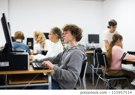Portrait of a fifteen-year-old schoolboy at a computer Portrait of a fifteen-year-old schoolboy at a computer 115957514