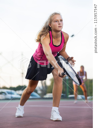 Woman tennis player training on court 115957547