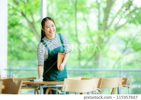 A woman working in a cafe A woman working in a cafe 115957687