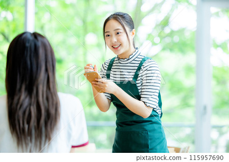 A woman working in a cafe 115957690