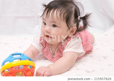 [Baby with twin tails starting to crawl] 115957820