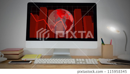 A computer screen displaying red world map and graphs sits on a desk 115958345