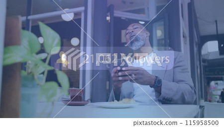 African American healthcare worker sitting in cafe, looking at smartphone 115958500
