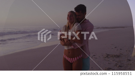Caucasian couple embracing on beach, waves in background 115958551