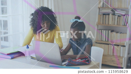 African American mother and daughter are looking at laptop in a home office 115958629