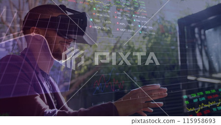 Biracial young man wearing virtual reality headset, interacting with digital data 115958693