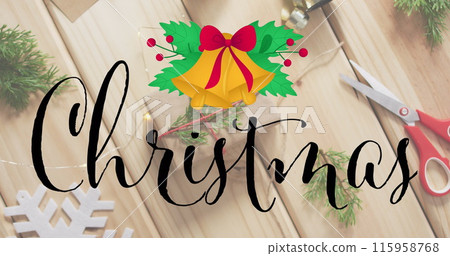 Wooden table holds Christmas decorations, scissors, and string for wrapping gifts 115958768