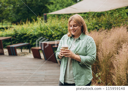 Happy redhead 30s Woman holding brown paper cup of coffee on public park background, Coffee to go on the city street. Food, rest, Take away concept. Happy redhead 30s Woman holding brown paper cup of coffee on public park background, Coffee to go on the city street. Food, rest, Take away concept. 115959148
