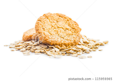 Tasty oatmeal cookies and rolled oat  isolated on white background. Tasty oatmeal cookies and rolled oat  isolated on white background. 115959365