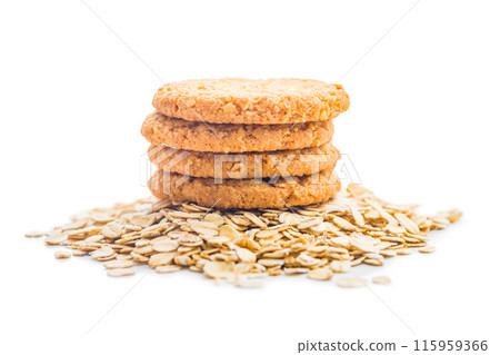 Tasty oatmeal cookies and rolled oat  isolated on white background. Tasty oatmeal cookies and rolled oat  isolated on white background. 115959366