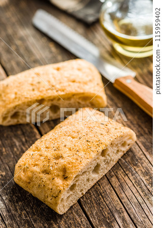 Italian ciabatta bread on wooden table. 115959402