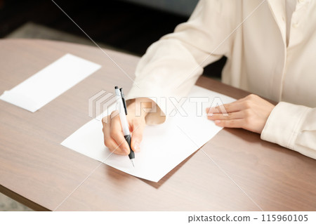 Woman writing a letter Woman writing a letter 115960105