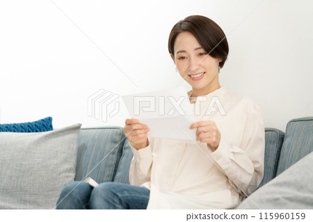 A woman reading a letter A woman reading a letter 115960159