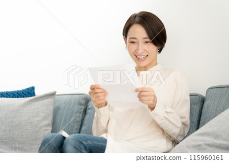 A woman reading a letter A woman reading a letter 115960161