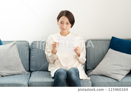A woman reading a letter A woman reading a letter 115960169