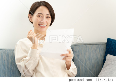 A woman reading a letter 115960185