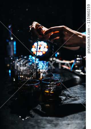 Bartender Preparing Multiple coffee Whiskey Cocktails at a Busy Bar Bartender Preparing Multiple coffee Whiskey Cocktails at a Busy Bar 115960259