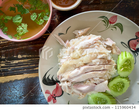 Steamed rice topped with chicken with soup on the table 115960434