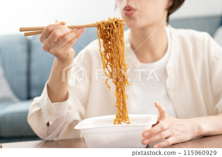 Woman eating cup yakisoba 115960929